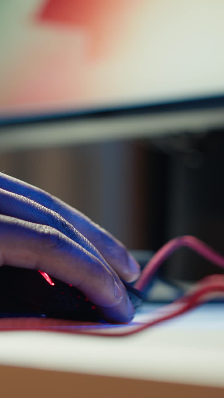Vertical video Gamer using keyboard and wired mouse to play videogames