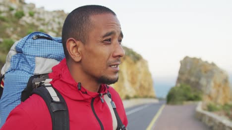 sporty mixed race man with prosthetic leg hiking