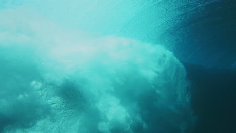 Glistening-rearview-of-water-spray-across-surface-from-breaking-wave