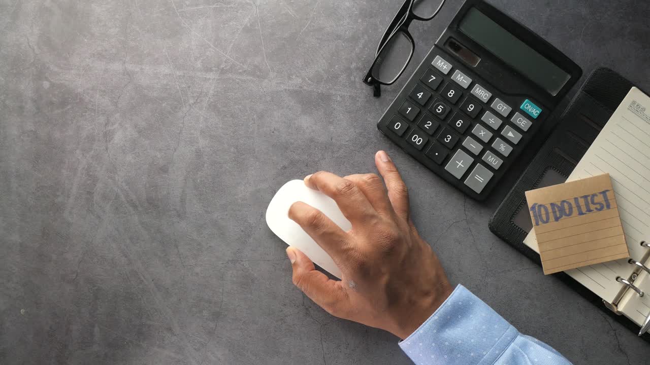 Person using computer mouse at a workplace