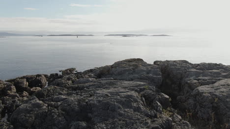 Drone-flying-slowly-over-rocks-out-over-the-Pacific