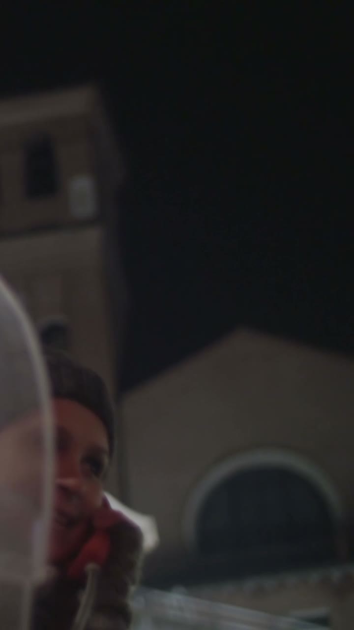 Woman in a phone booth at night