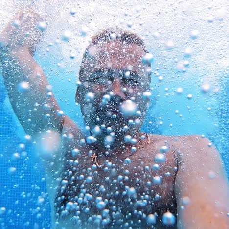 man swimming in pool