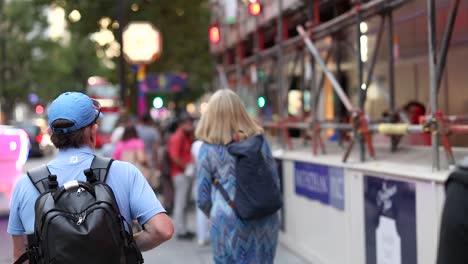 men and women walking on a busy street