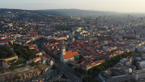 Wide-drone-footage-of-Bratislava,-Slovakia-with-the-Saint-Martin's-Cathedral-in-the-foreground