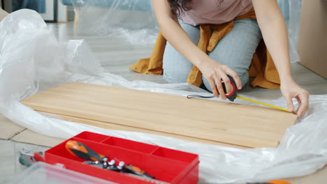 woman assembling furniture