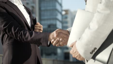 closeup shot of office workers meeting and shaking hands