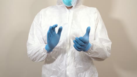 doctor in ppe suit clapping in front of the camera