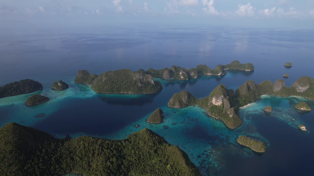 View on paradise islands with crystal clear waters in Raja Ampat, Wayag, Indonesia. Lost Paradise