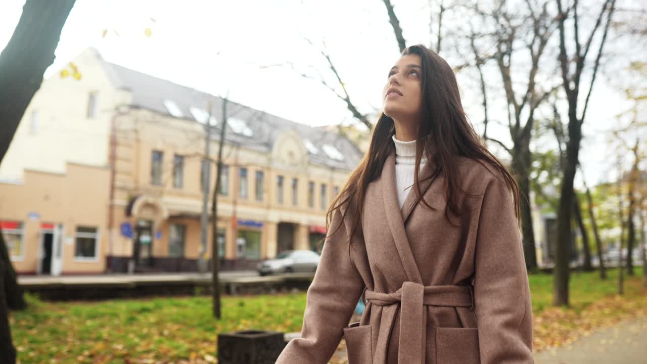 Woman Walking in an Autumn City Park