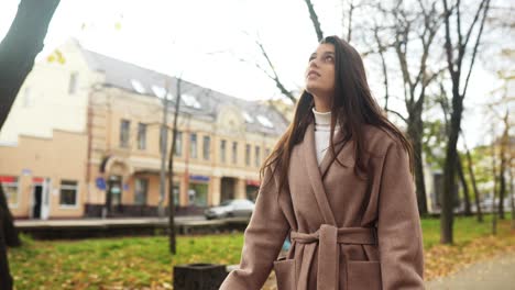 woman walking in an autumn city park