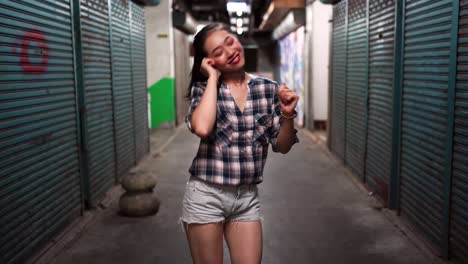 Woman-with-headset-standing-in-underground-corridor