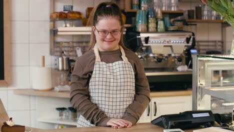 portrait of down syndrome girl as a worker in the cafe