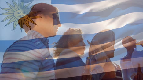 composite video of uruguay flag against group of diverse friends drinking beers together outdoors