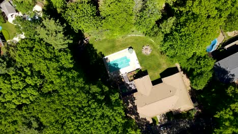 Drone-rising-from-yard-to-show-winterized-pool-in-late-spring