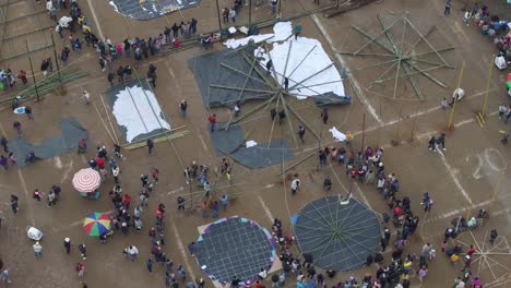 people prepare giant kites for all saint's day in sumpango, aerial