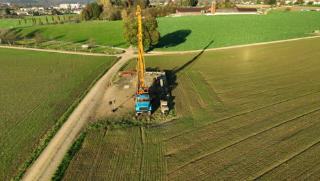 Exploration-mining-drill-truck-in-golden-fall-light-drone-round-shot