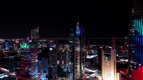 dazzling 4k aerial of kuwait city glowing at night. high-rise towers, colorful lights, and urban vibrance captured in cinematic detail. great for city, travel, and commercial footage.