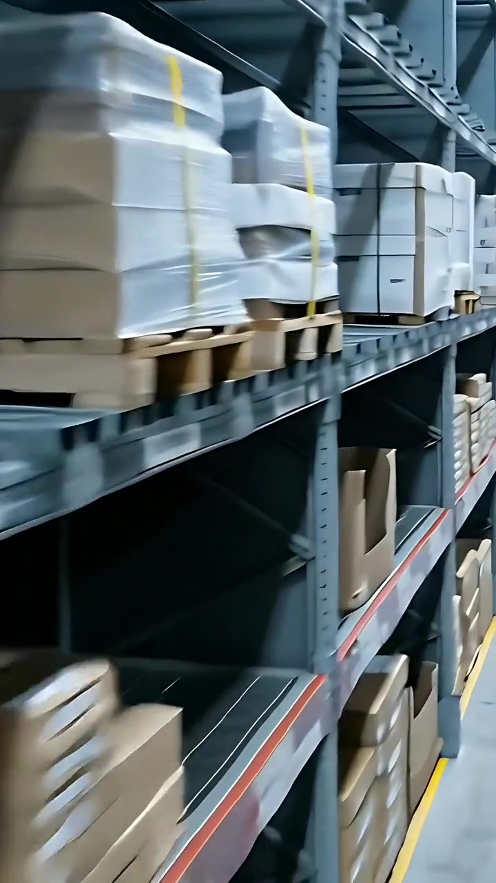 Vertical video: Moving camera revealing pallet racking in warehouse aisle, showing storage plan