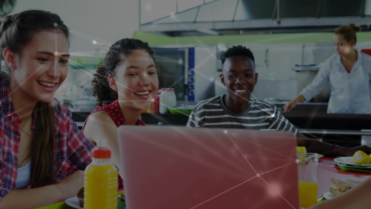 3 pupils leaning on pink laptop in school one tapping starting work camera zooming overlaying frame