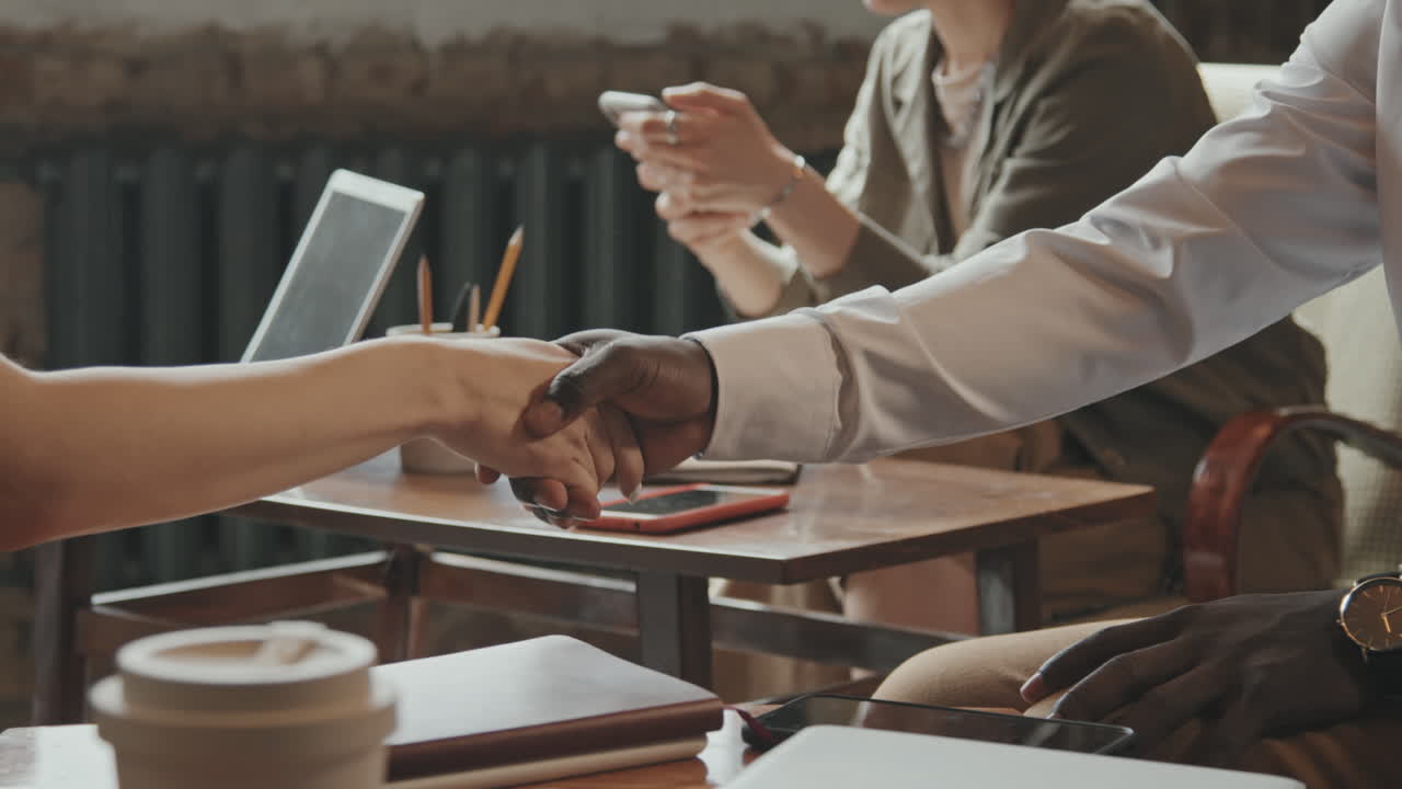 Male and Female Business Partners Shaking Hands