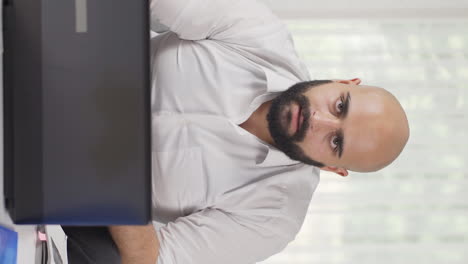 Vertical-video-of-Home-office-worker-man-says-shhh-to-camera.