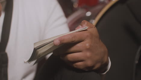 Close-Up-View-Of-Latin-ManÂ¬Â¥S-Hands-Writing-In-The-Notebook-In-Recording-Studio