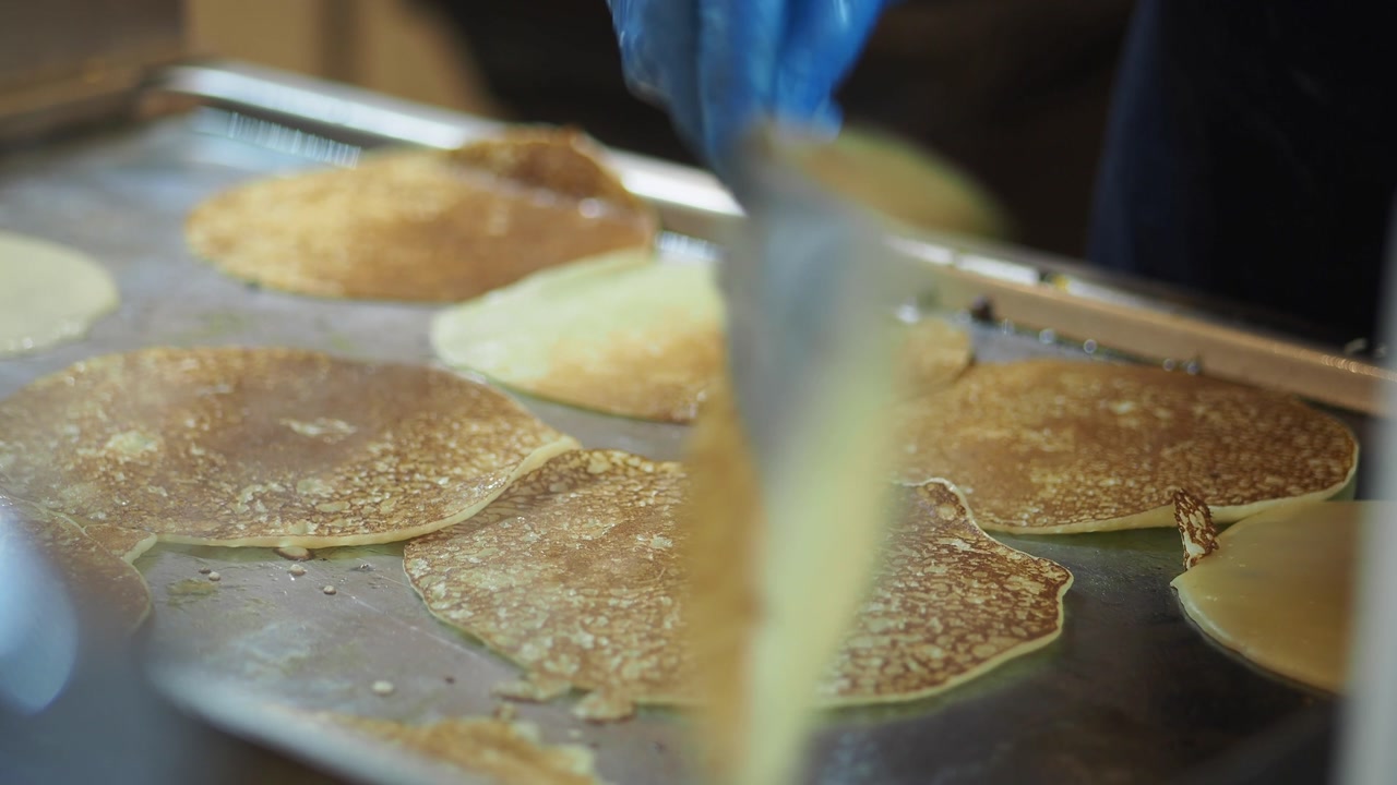 Close-up of Pancakes Frying on a Hot Griddle