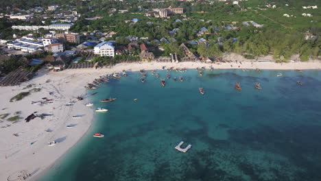 Awesome-aerial-shot-of-shoreline-and-turquoise-ocean-in-zanzibar-at-sunny-day,-tanzania