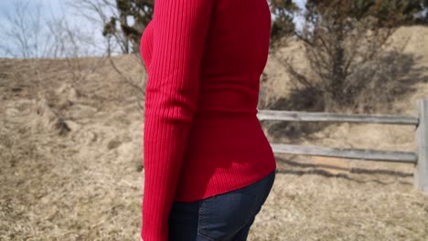 woman in red top and jeans with gimbal video moving around.