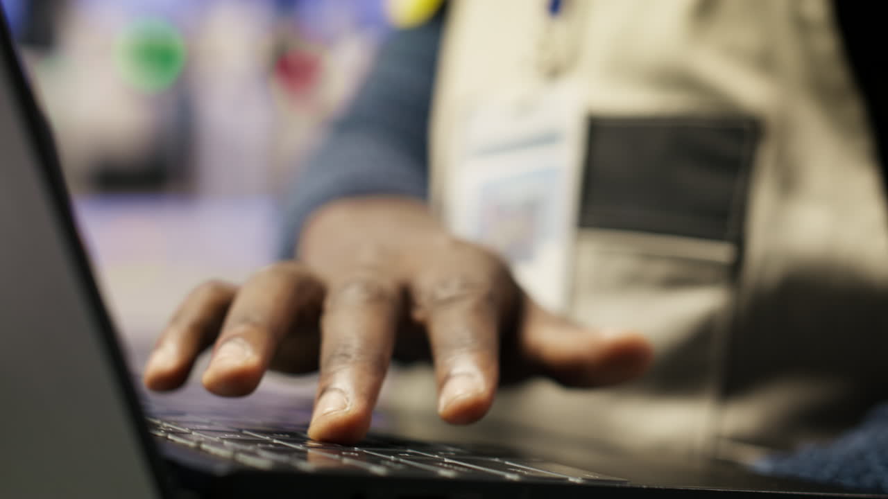 Vertical video Close up of smart factory worker using laptop to test automated systems