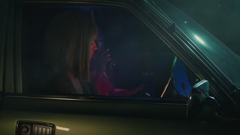 two women in a vintage car at night