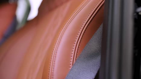 close view of leather interior of luxury car, beige. comfortable perforated seats in business sedan for comfortable ride.