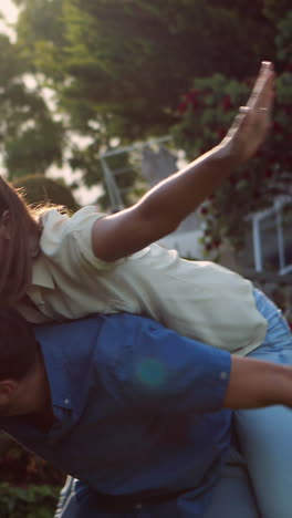 handsome man giving piggy back to his girlfriend