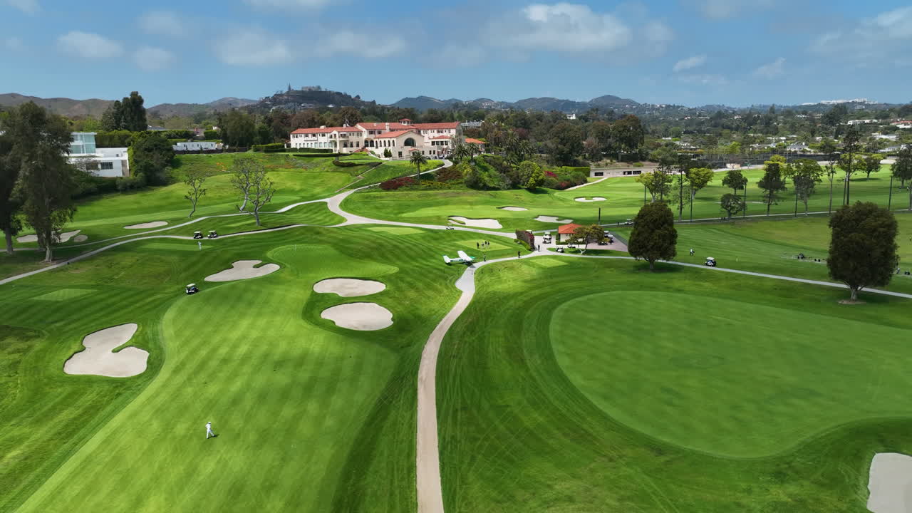 Aerial view of a plane emergency landed on a golf course in sunny Los Angeles,