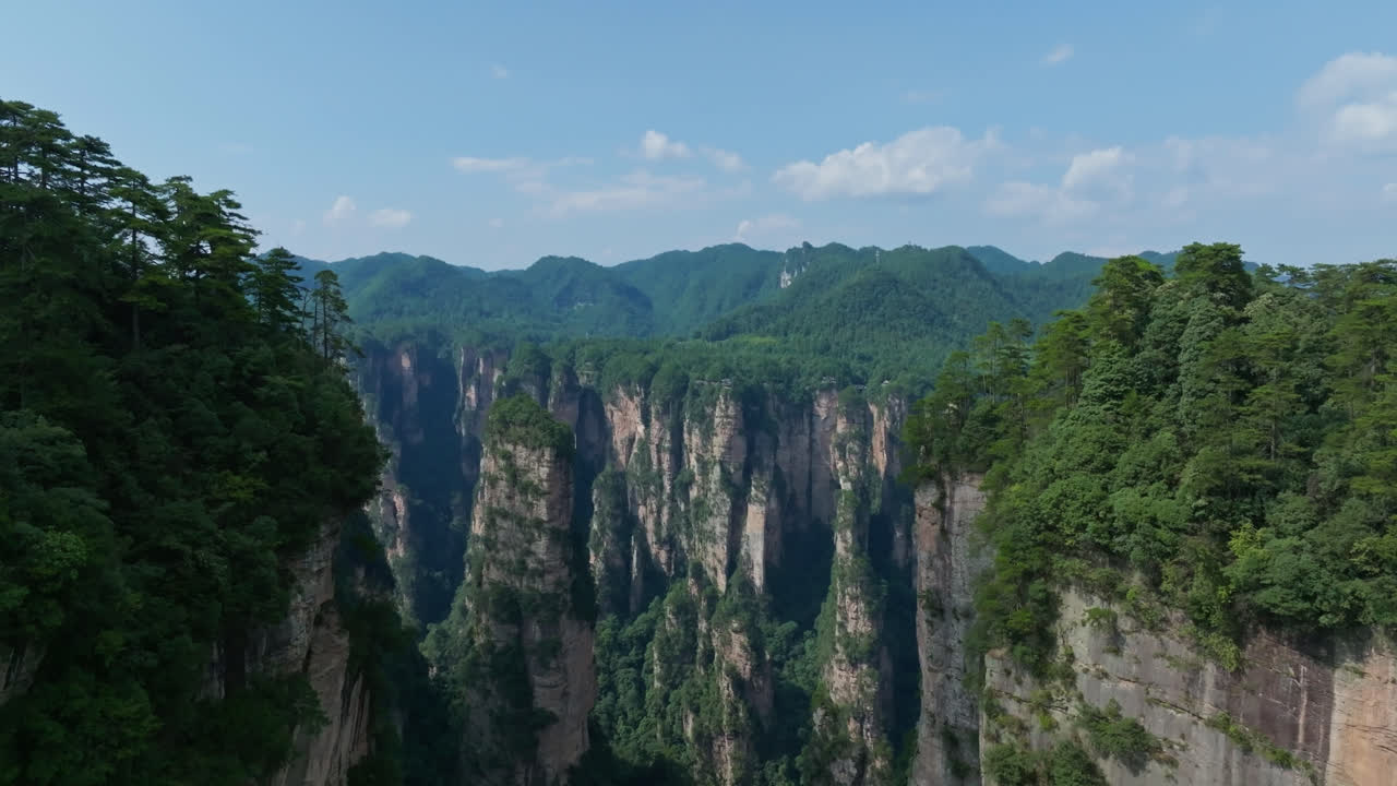 Aerial tilt shot rising in middle of rocky quartz pillars, in Wulingyuan, Zhangjiajie