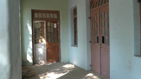 Detail-shot-of-a-brown-wooden-door-and-windwow-at-Goolbai-Maternity-Home-in-karachi