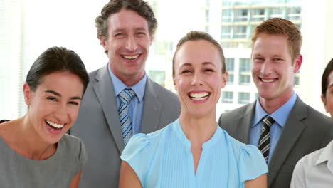 Happy-business-people-looking-at-camera-