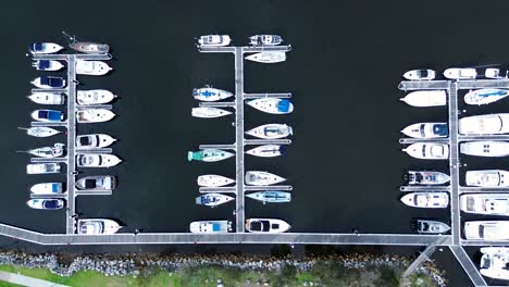 Drone-aerial-bird's-eye-landscape-of-yachts-boats-docked-in-waterfront-harbour-wharf-Catalina-travel-tourism-boating-Batemans-Bay-South-Coast-Australia