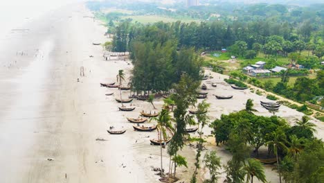 aerial of kuakata sea beach with wooden fishing boats close to fishing village of bangladesh
