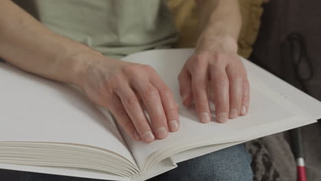 close up view of man hands touching a book