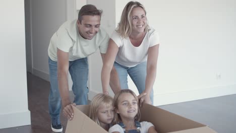 Cheerful-parents-and-kids-having-fun-while-moving