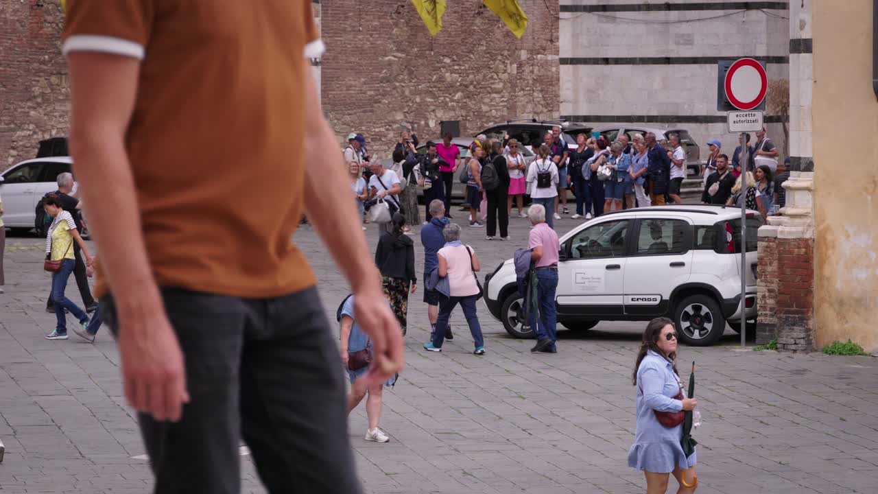 Tourists Visiting a Historic City Plaza in Italy