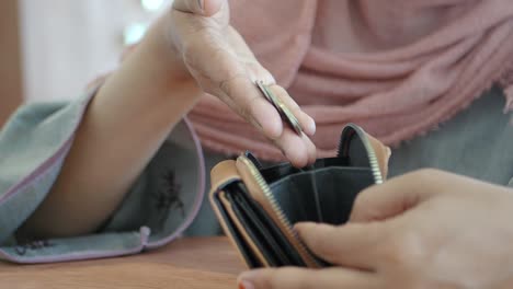 woman checking her empty wallet