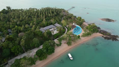 luxury-resort-on-a-white-sand-beach-island-in-thailand-during-sunset,-aerial