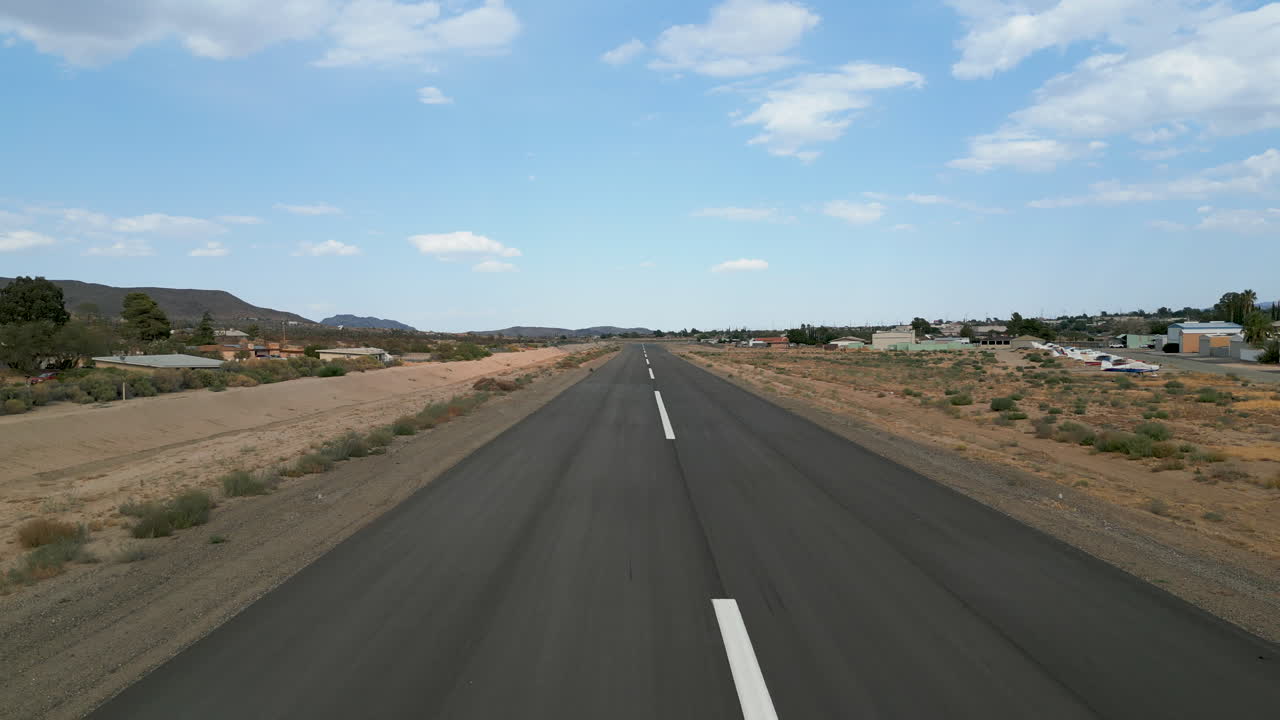 Empty Runway at a Small Airfield in a Desert Landscape