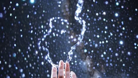 hand reaching towards the stars in a cosmic water splash
