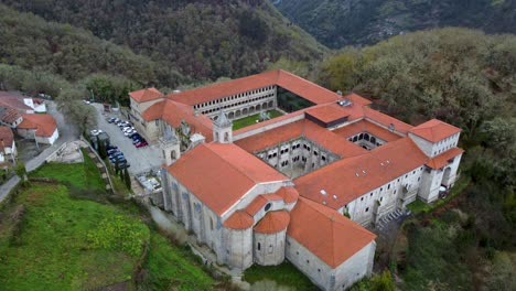 Aerial-orbit-around-sacred-religious-monastery-nestled-on-mountain-in-Spain