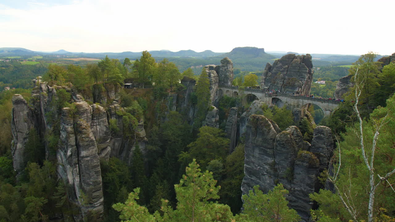 Bastei Elbsandsteingebirge Sachsen Elbe sandstone formations rising above dense green forests Mountains, showcasing the region’s natural beauty and rugged Terrain
