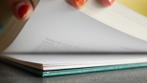 Close up of an open book with green cover